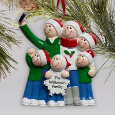 a family ornament hanging from a christmas tree