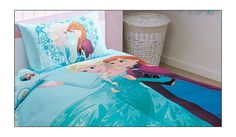 the bed is made up with two princesses and one has an aqua blue comforter