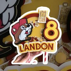 a hand holding up a sticker with the number eight on it and an image of a dog