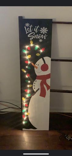 a lighted sign with a snowman on it