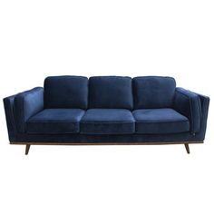 a blue velvet couch with wooden legs