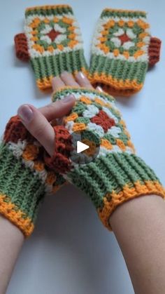 someone is holding their hand out to show off the crocheted mitts they are made from