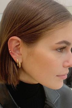 a close up of a person wearing some kind of earring on their left ear