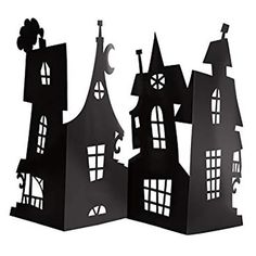 three black paper cut out houses with windows and bats on them, one in the shape of a house