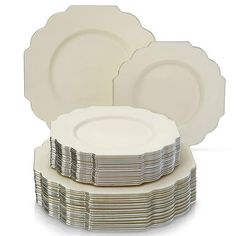 a stack of white plates sitting on top of each other