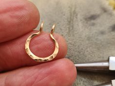 ❤️ NO PIERCING REQUIRED      Slightly hammered fake septum ring ► Please choose material: 100% 14K gold filled 100% Silver Sterling  Inner diameter: 8 mm approx. Gauge (wire thickness) 18g ♥ Dear buyer just for knowledge: HOW TO PUT IT ON? 1.Gently open the cuff . 2.Position the cuff around your nasal septum 3.Firmly pinch the cuff with your fingers. 4.Make sure it stay in the place WHAT IS GOLD FILLED? Gold filled is an actual layer of gold-pressure bonded to another metal. It does not flake of Fake Septum Ring, Nasal Septum, Fake Nose Ring, Faux Septum, Septum Hoop, Septum Nose Rings, Fake Nose Rings, Fake Nose, Nose Jewelry