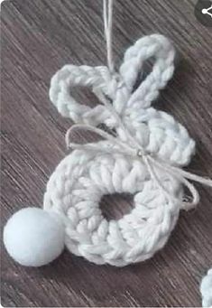 a crocheted ornament with two balls attached to it on a table