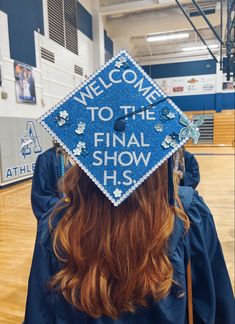 a graduate wears a blue graduation cap that reads welcome to the final show hss