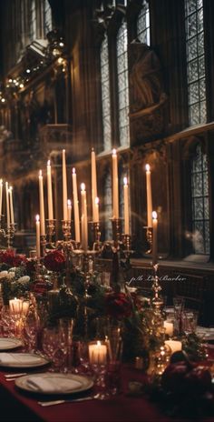 a long table with candles and flowers on it