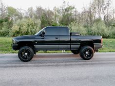 a black truck is parked on the side of the road