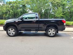 a black pickup truck parked in a parking lot