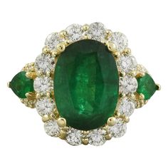 Introducing our stunning 6.00 Carat Natural Emerald Ring crafted in luxurious 14K Solid Yellow Gold. This exquisite piece features a captivating center emerald weighing 3.90 Carats, cut in an elegant oval shape measuring 12.00x10.00 millimeters. Complementing the center stone are two pear-shaped side emeralds, totaling 0.20 Carats, adding a touch of sophistication to the design. Adorned with sparkling diamonds weighing 1.90 carats, boasting a delightful F-G color and VS2-SI1 clarity. With a total ring weight of 7.6 grams, this masterpiece showcases a face measuring 17.60x14.65 millimeters. Stamped for authenticity, this ring is a timeless symbol of elegance and refinement. 6.00 Carat Natural Emerald 14K Solid Yellow Gold Diamond Ring Stamped: 14K Total Ring Weight: 7.6 Grams Center Emerald Natural Emerald Rings, Yellow Gold Diamond Ring, Emerald Diamond Ring, Gold Diamond Ring, Ring Crafts, Emerald Jewelry, Pear Shaped Diamond, Gold Diamond Rings, Emerald Diamond