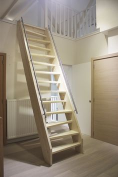 an empty room with stairs leading up to the second floor