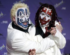 two men with clown makeup on their faces and one is holding his arm around the other