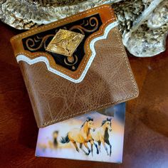 Western Genuine Leather Longhorn logo Wallet  Bifold   Hand tooled design floral and geometric. Comes in a box. Brand new western wallet *             Bi-fold style *             plain   pattern on the back *             Made of genuine hand tooled leather *             Measures 41/2 inches long by 3 1/2 inches wide, about 3/8 inch thick (closed) *            5  credit card slots,                2 cash compartments .             2 ID clear slots .              1 zippered coin pocket .               1 large zippered pocket .               1 extra pocket at the back. .              Beautiful Longhorn concho .            Comes in a Western style box. Hand Tooled Bifold Wallet, Vintage Hand-tooled Trifold Wallet, Western Style Leather Rectangular Wallet, Western Style Brown Trifold Wallet With Card Slots, Western Leather Wallets With Card Slots, Western Leather Wallet With Card Slots, Mens Wallet, Style Box, Leather Short