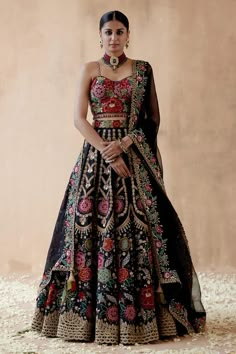 Black lehenga with foliage vintage pattern, multicolor thread, sequin, bead and cutdana embroidery. Paired with sleeveless embroidered blouse and dupatta with embroidered border. Components: 3 Pattern: Embroidery Type Of Work: Thread, sequin, bead, cutdana, floral Neckline: Sweetheart neck Sleeve Type: Sleeveless Fabric: Raw Silk, Organza Color: Black Other Details:  Cutwork hem Border embroidered sheer dupatta Crystal drops on blouse hem Model height: 5ft 9inches, wearing size S Note: Necklace Aesthetic Lehengas, Floral Embroidery Lehenga, Lehenga Styling, Indian Streetwear, Salwar Suits For Women, Floral Thread Embroidery, Raw Silk Embroidery, Christian Wedding Gowns, Cutdana Embroidery