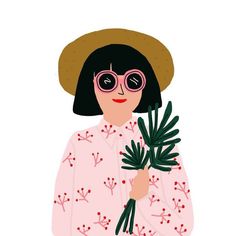 a woman in a hat and glasses holding a plant with leaves on it's arms