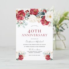 an anniversary card with red flowers and greenery