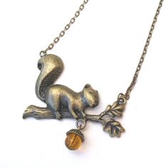 Squirrel has been busy collecting acorns for the winter. Adark honey coloured glass bead acorn is suspended from his branch. The branch and squirrel measures almost 2 1/2 inches (60 mm) across.The chain is antiqued brass with a lobster clasp and extension chain.  This necklace comes in a gift box. Squirrel Necklace, Bronze Necklace, Coloured Glass, Bib Necklaces, Honey Colour, Amber Color, Glass Bead, Beautiful Necklaces, Antique Brass