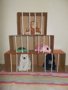 three stuffed animals are sitting on top of the cardboard boxes that have been placed in them