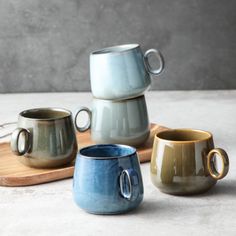 three cups sitting on top of a wooden tray