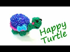 a toy turtle is holding a flower in it's hand and the words happy turtle are