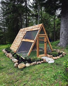 a small house made out of wood with a chicken in it's door and windows