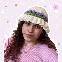 a woman with curly hair wearing a crocheted hat