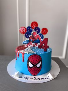 a spiderman birthday cake on a table