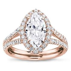 a yellow gold engagement ring with a pear shaped diamond center and pave set shoulders