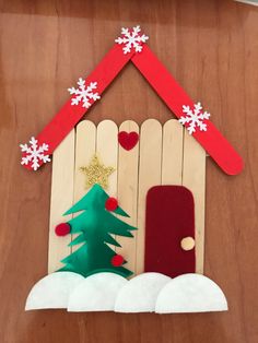 a house made out of popsicle sticks with a christmas tree on the front door