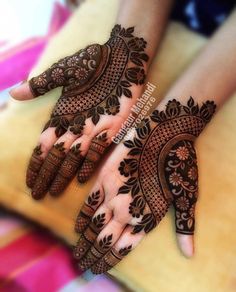 two hands with henna designs on them