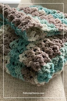 a crocheted blanket sitting on top of a couch