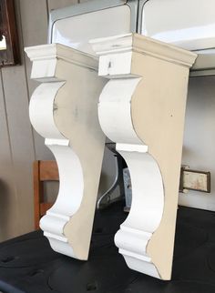 there are two white wooden pillars on top of a black table