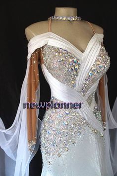 a white dress with beading on it