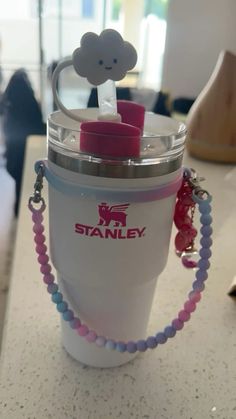 a cup with a chain attached to it