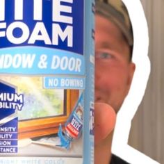 a man holding up a white foam window and door adhesivent in front of his face