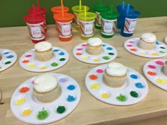 cupcakes on plates with plastic cups and straws in the background, ready to be eaten