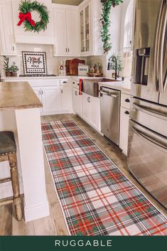 a kitchen decorated for christmas with plaid rugs