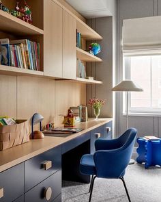 a blue chair sitting in front of a wooden desk