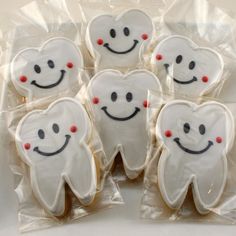 decorated cookies in the shape of teeth and smiling faces