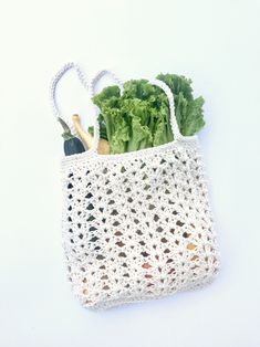 a crocheted shopping bag with vegetables in it