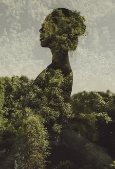 a woman's face is covered in plants and trees as she looks into the distance