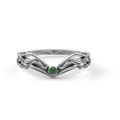 a white gold ring with an emerald stone in the center and two leaves on each side