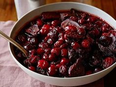 a bowl filled with cranberry sauce on top of a table