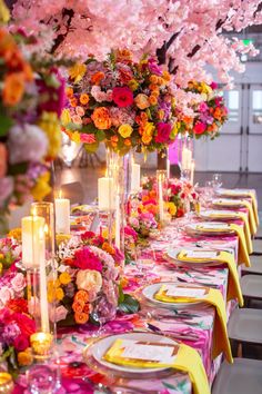 a long table is set with flowers and candles for an elegant dinner or party event