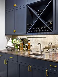 a kitchen with blue cabinets and marble counter tops