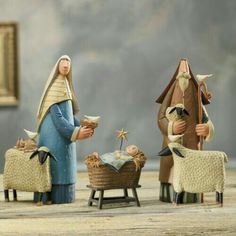 three nativity figurines are shown in front of a painting