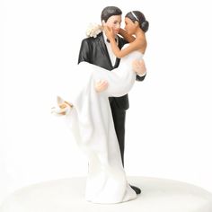 a bride and groom figurine holding each other