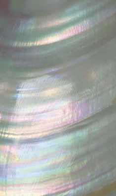 a close up view of an iridescent colored object